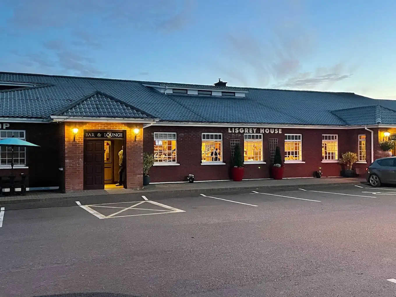 Exterior image of Lisgrey House at dusk, with the building glowing faintly in the background