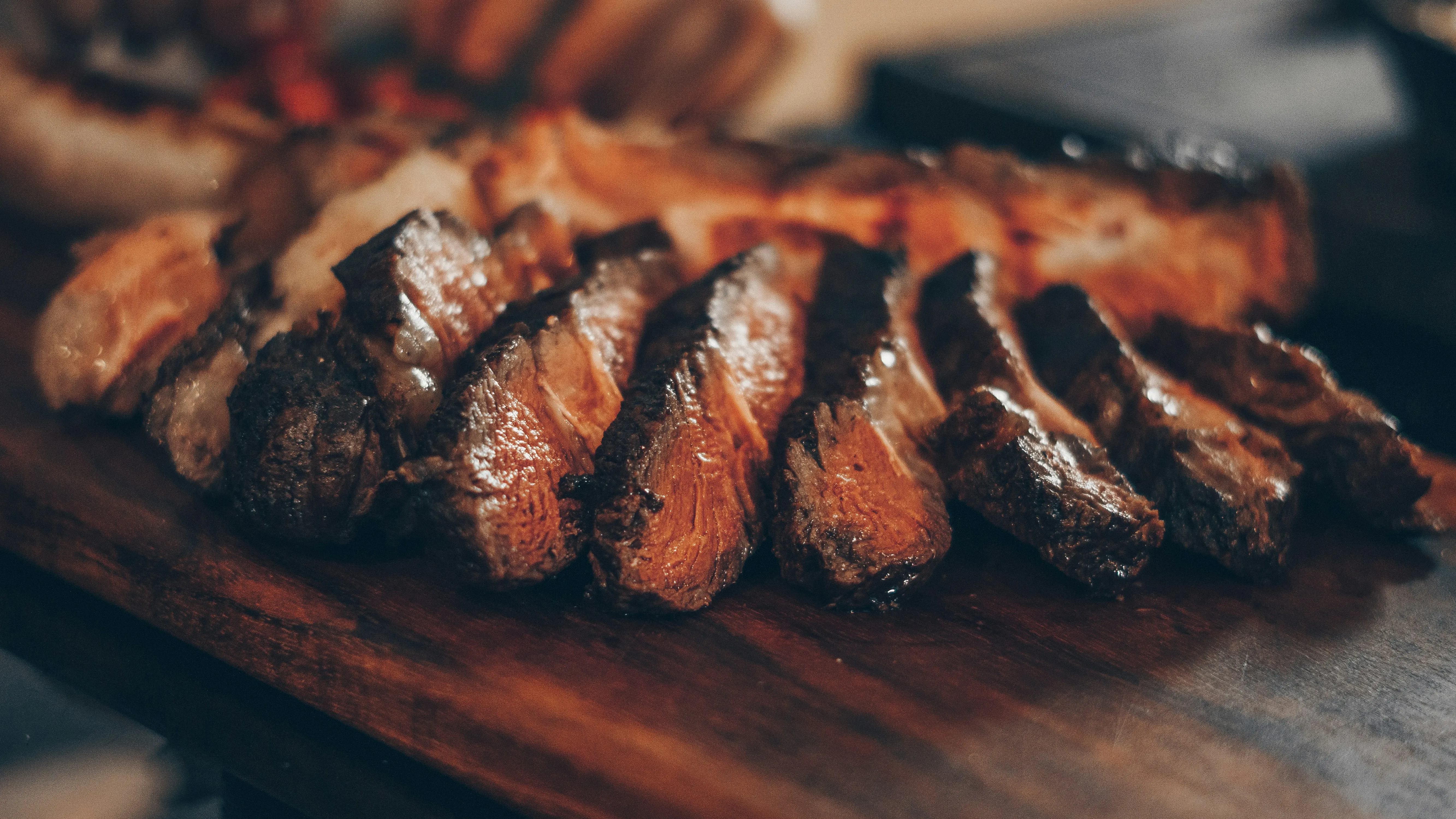 A steak served sizzling on a hot slate